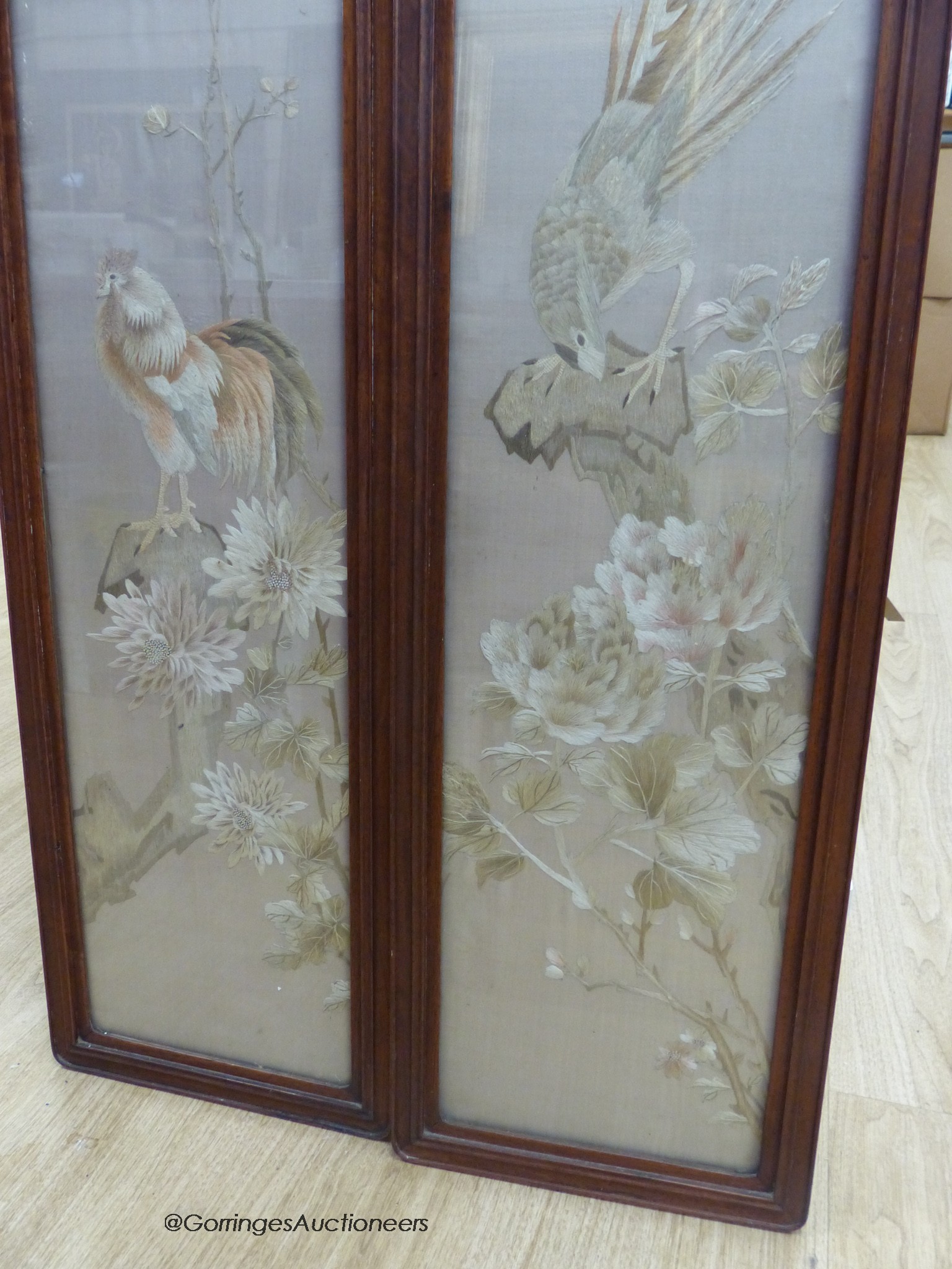 A pair of late 19th century Chinese embroidered silk pictures, in hongmu frames, 111 cm x 29 cm in total